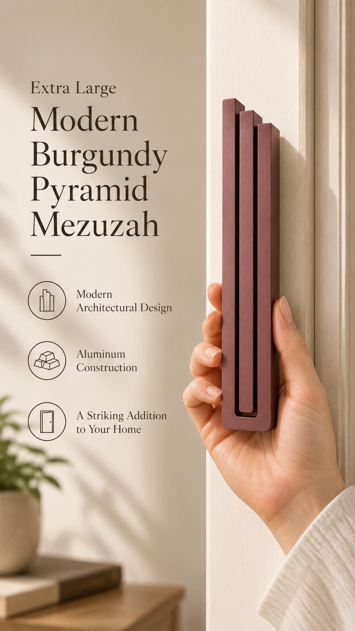 Hand holding the Extra Large Modern Burgundy Pyramid Mezuzah upright, revealing its muted burgundy wine-red aluminum mezuzah cover, slender three-bar Pyramid design and graduated top beside illustrated product features for minimalist Jewish home Judaica