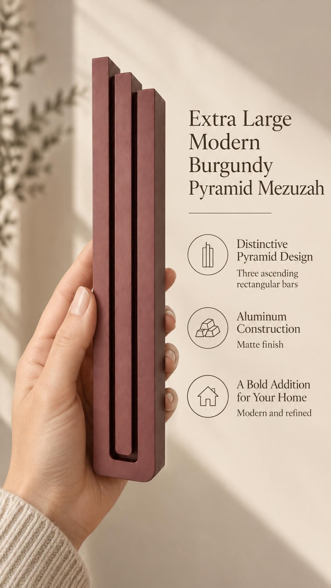 A hand presents the Extra Large Modern Burgundy Pyramid Mezuzah with its muted burgundy wine-red aluminum mezuzah cover facing forward, highlighting the clean graduated bars and geometric vertical profile beside design illustrations for a minimalist Jewish doorway accent