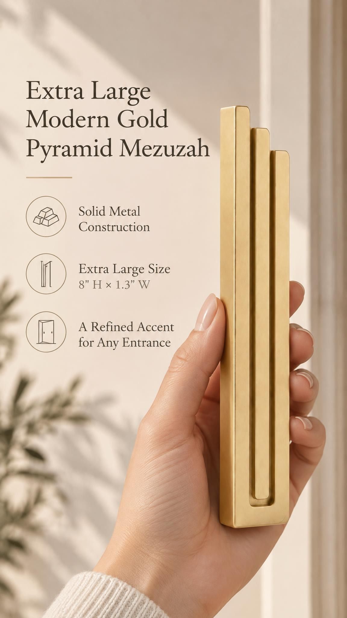 Hand holding the Extra Large Modern Gold Pyramid Mezuzah upright, revealing its warm metallic gold aluminum mezuzah cover, slender three-bar Pyramid design and graduated top beside illustrated product features for minimalist Jewish home Judaica