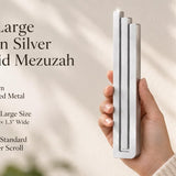 Extra Large Modern Silver Pyramid Mezuzah pictured in hand as a softly brushed silver aluminum mezuzah cover with three graduated bars and a minimalist stepped design, alongside its name and illustrated product features in a wide social-sharing image