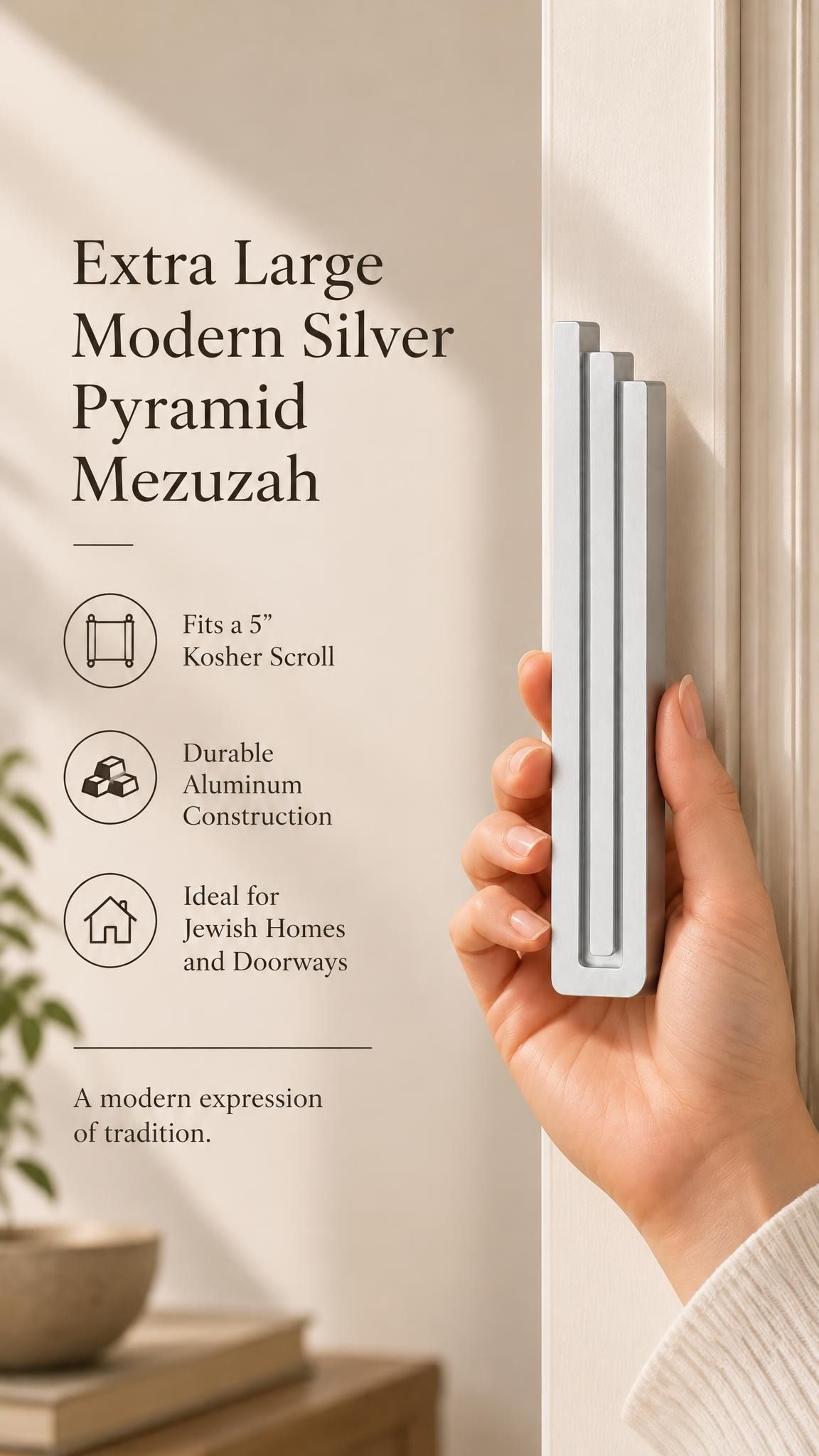 Hand holding the Extra Large Modern Silver Pyramid Mezuzah upright, revealing its softly brushed silver aluminum mezuzah cover, slender three-bar Pyramid design and graduated top beside illustrated product features for minimalist Jewish home Judaica