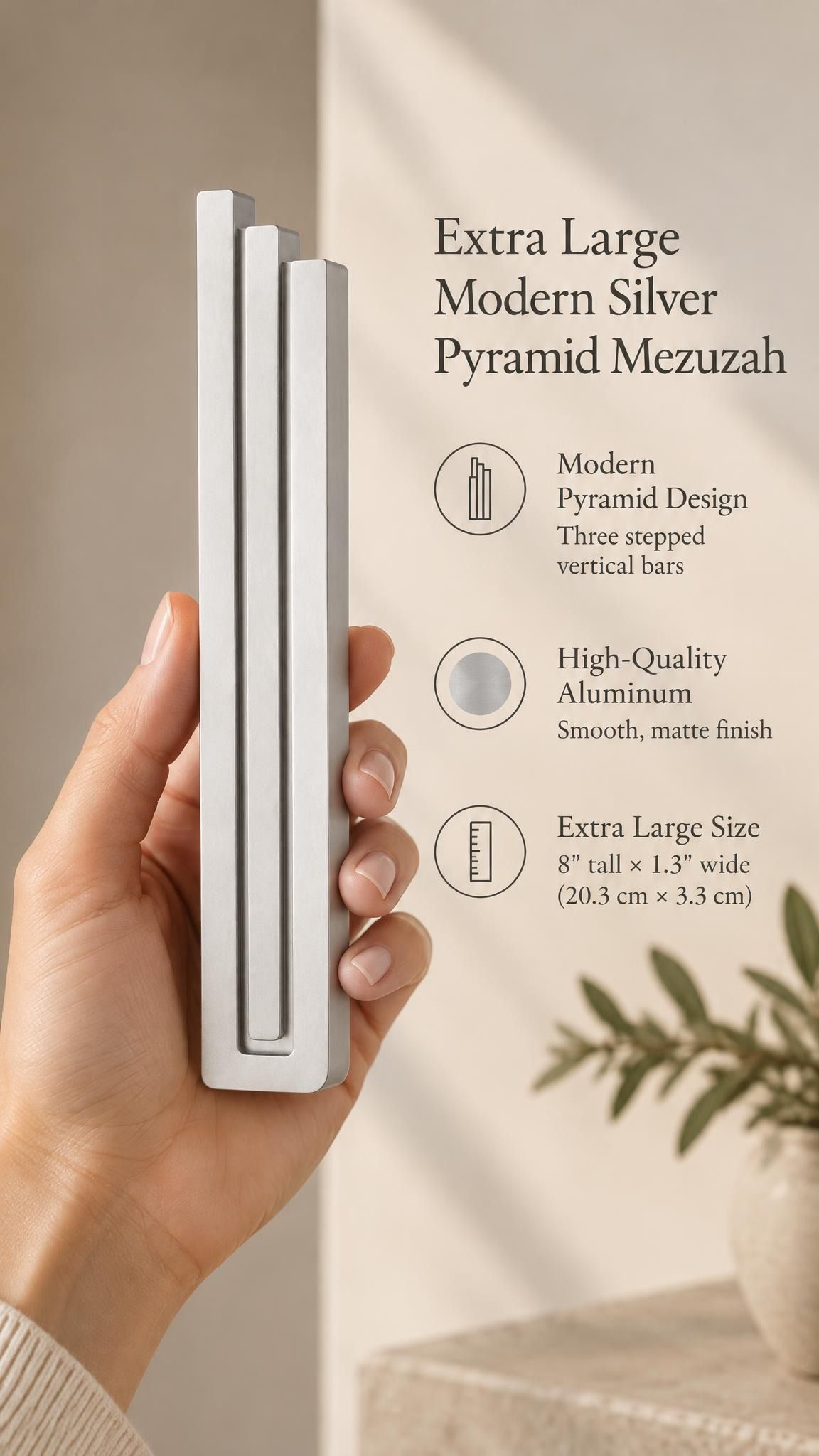 A hand presents the Extra Large Modern Silver Pyramid Mezuzah with its softly brushed silver aluminum mezuzah cover facing forward, highlighting the clean graduated bars and geometric vertical profile beside design illustrations for a minimalist Jewish doorway accent
