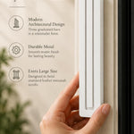 Extra Large Modern White Pyramid Mezuzah held beside a doorpost, with the smooth matte white aluminum mezuzah cover shown close enough to reveal its three stepped bars and rounded lower edge alongside product-name and design callouts for this contemporary Judaica piece