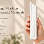 Extra Large Modern White Pyramid Mezuzah pictured in hand as a smooth matte white aluminum mezuzah cover with three graduated bars and a contemporary stepped design, alongside its name and illustrated product features in a wide social-sharing image