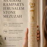 Hand-held view of the extra-large Shaddai Ramparts Jerusalem Stone Mezuzah showing its height, texture, Hebrew engravings, and gold lettering.