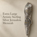 Premium image of the large sterling silver Jerusalem Mezuzah with city relief design on a stone background