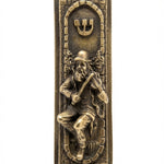 Brass finish Fiddler on the Roof Mezuzah with detailed engravings, Hebrew letters, and decorative motifs, shown on a white studio surface with subtle reflection.