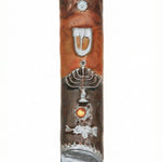 Passionate pewter mezuzah with enamel featuring a menorah and Hebrew letter Shin, displayed on a white studio background with soft reflection.