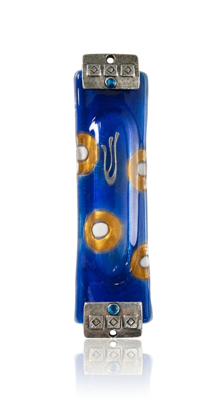Elegant fused-glass Mezuzah with blue and gold circles, textured silver accents at top and bottom, displayed on a white studio background with soft reflection.