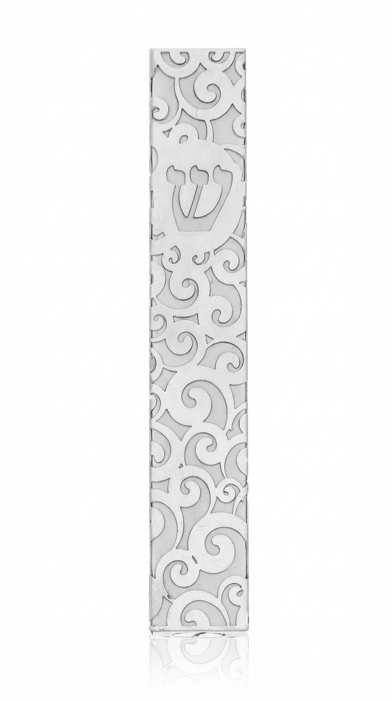 High-resolution image of a metal Gale Mezuzah with elegant swirl design, mounted outdoors with double-sided tape, showcasing fine details and craftsmanship.