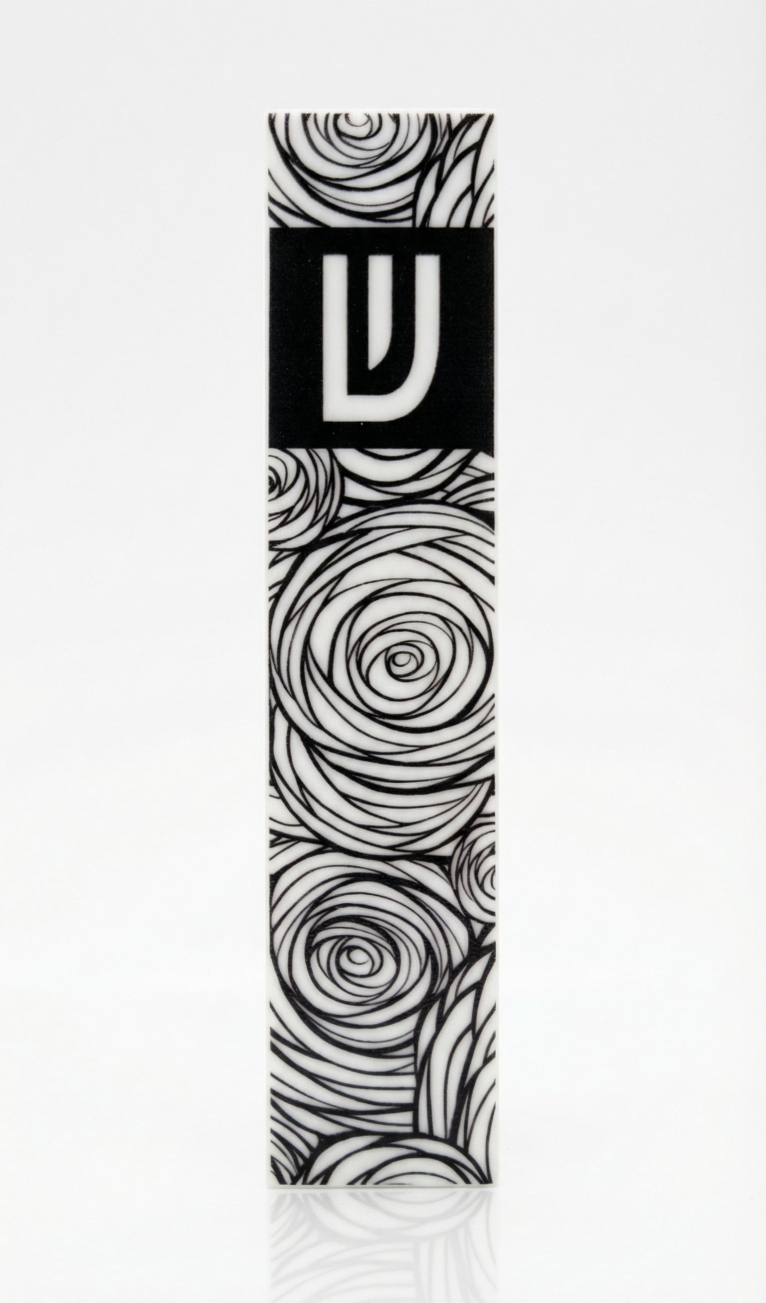 Elegant Israeli-made acrylic garden mezuzah with Hebrew inscriptions, detailed carvings, and decorative motifs, displayed with soft reflection on white background.