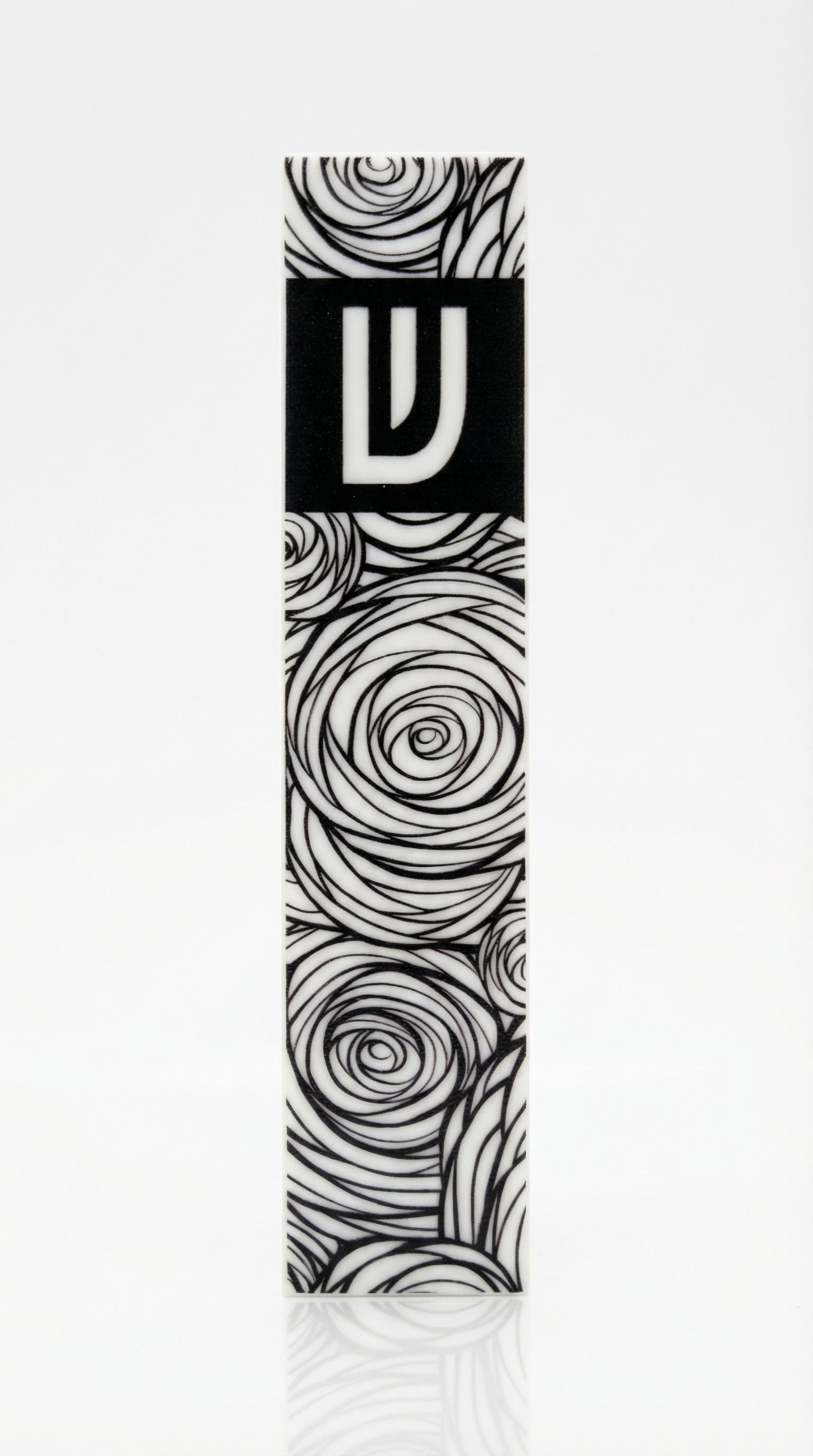 Elegant Israeli-made acrylic garden mezuzah with Hebrew inscriptions, detailed carvings, and decorative motifs, displayed with soft reflection on white background.