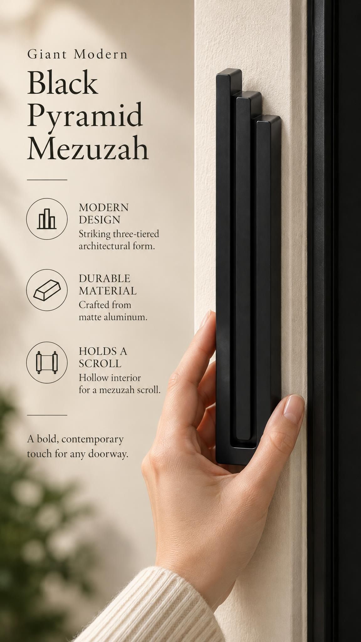 Giant Modern Black Pyramid Mezuzah held beside a doorpost, with the deep matte black aluminum mezuzah cover shown close enough to reveal its three stepped bars and rounded lower edge alongside product-name and design callouts for this architectural Judaica piece