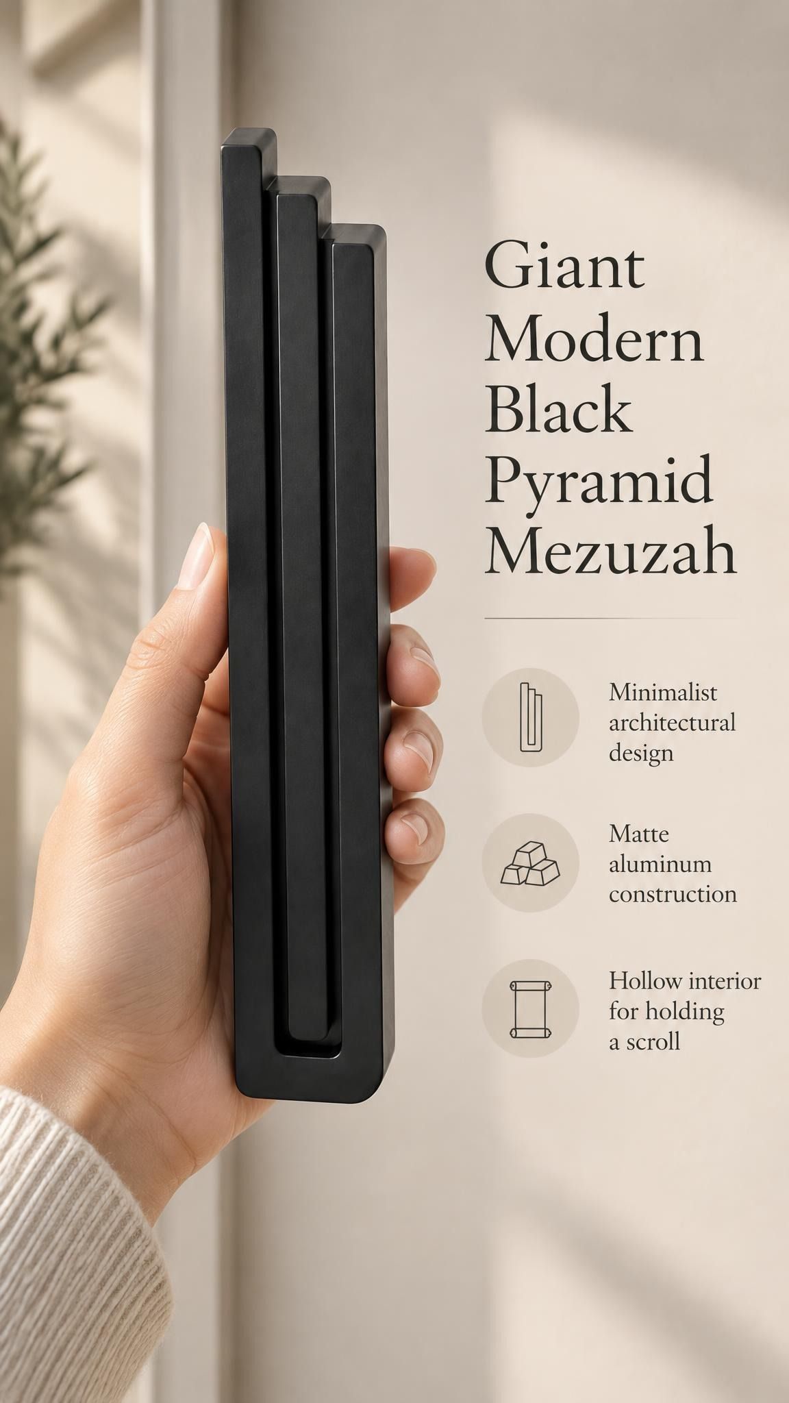 Hand holding the Giant Modern Black Pyramid Mezuzah upright, revealing its deep matte black aluminum mezuzah cover, slender three-bar Pyramid design and graduated top beside illustrated product features for architectural Jewish home Judaica