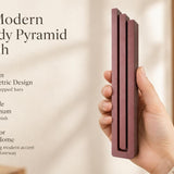 Giant Modern Burgundy Pyramid Mezuzah pictured in hand as a muted burgundy wine-red aluminum mezuzah cover with three graduated bars and a architectural stepped design, alongside its name and illustrated product features in a wide social-sharing image