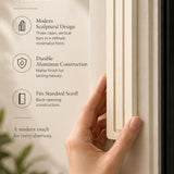 Giant Modern Cream Pyramid Mezuzah held beside a doorpost, with the warm ivory cream aluminum mezuzah cover shown close enough to reveal its three stepped bars and rounded lower edge alongside product-name and design callouts for this contemporary Judaica piece