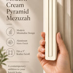 A hand presents the Giant Modern Cream Pyramid Mezuzah with its warm ivory cream aluminum mezuzah cover facing forward, highlighting the clean graduated bars and geometric vertical profile beside design illustrations for a contemporary Jewish doorway accent
