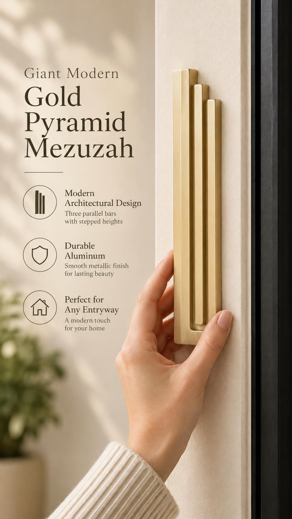 Giant Modern Gold Pyramid Mezuzah held beside a doorpost, with the warm metallic gold aluminum mezuzah cover shown close enough to reveal its three stepped bars and rounded lower edge alongside product-name and design callouts for this architectural Judaica piece