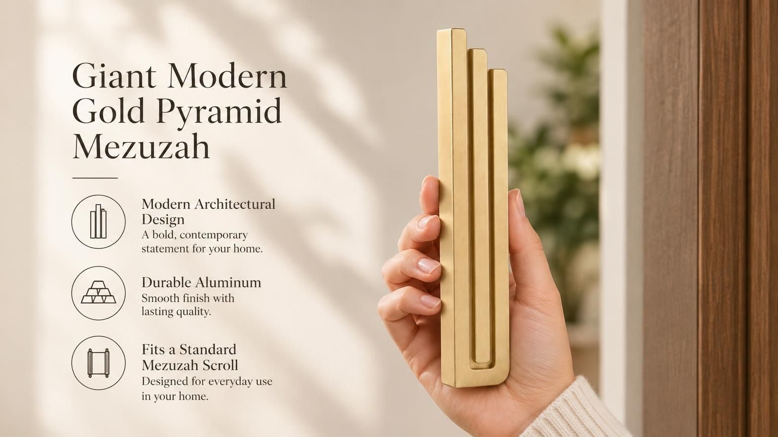 Giant Modern Gold Pyramid Mezuzah pictured in hand as a warm metallic gold aluminum mezuzah cover with three graduated bars and a architectural stepped design, alongside its name and illustrated product features in a wide social-sharing image