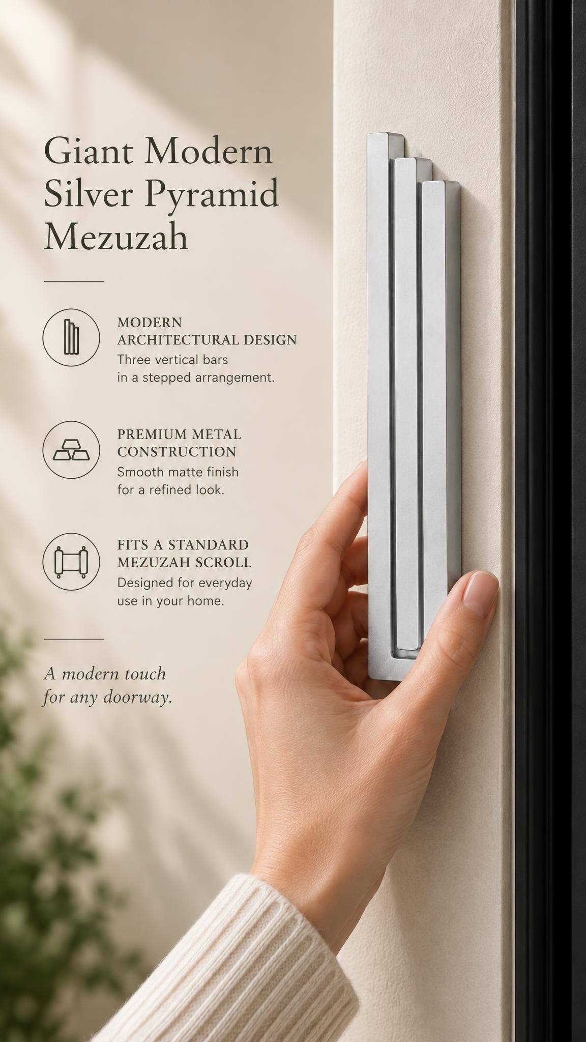 Giant Modern Silver Pyramid Mezuzah held beside a doorpost, with the softly brushed silver aluminum mezuzah cover shown close enough to reveal its three stepped bars and rounded lower edge alongside product-name and design callouts for this architectural Judaica piece