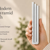 Giant Modern Silver Pyramid Mezuzah pictured in hand as a softly brushed silver aluminum mezuzah cover with three graduated bars and a architectural stepped design, alongside its name and illustrated product features in a wide social-sharing image