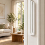 Giant Modern White Pyramid Mezuzah mounted vertically on a white interior doorpost, where its smooth matte white aluminum mezuzah cover and three graduated bars create a architectural Judaica accent with clean geometric lines against the pale doorframe
