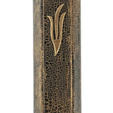 Elegant gold and black fusion mezuzah with intricate engraved Hebrew lettering and decorative motifs, displayed on a white studio background with subtle reflection.