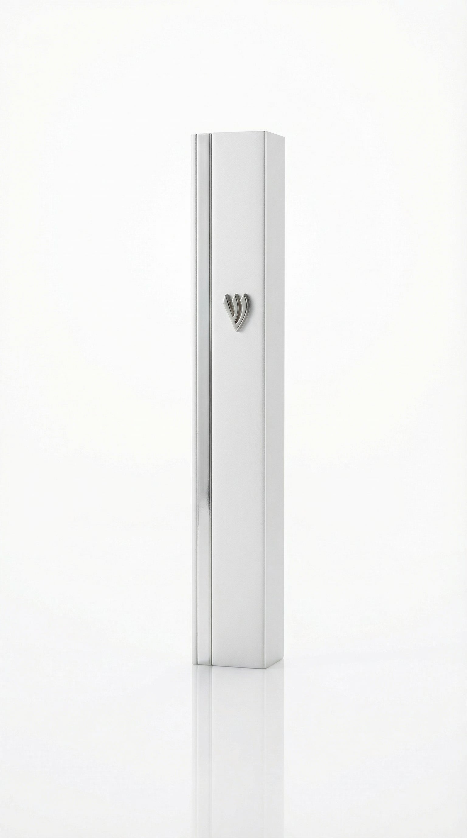 Gold mezuzah with intricate carvings and Hebrew inscriptions against a bright white background with soft reflection