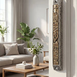 Elegant Golden Cityline pewter and brass mezuzah mounted on a doorway in a refined interior setting. Classic and architectural style.