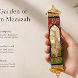 Hand-held view of the Golden Jerusalem Garden mezuzah with Jerusalem scene, floral details, and ornate gold trim, in a premium editorial style.