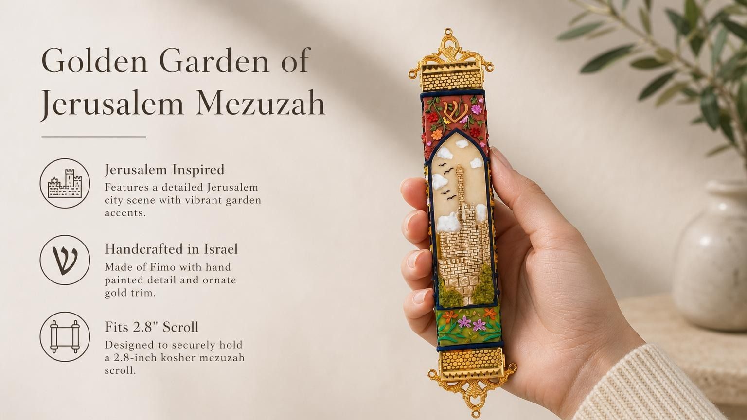 Hand-held view of the Golden Jerusalem Garden mezuzah with Jerusalem scene, floral details, and ornate gold trim, in a premium editorial style.