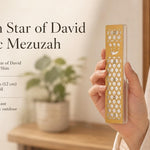 Person holding a Golden Star of David Acrylic Mezuzah showing its detailed gold overlay and crystal accents.