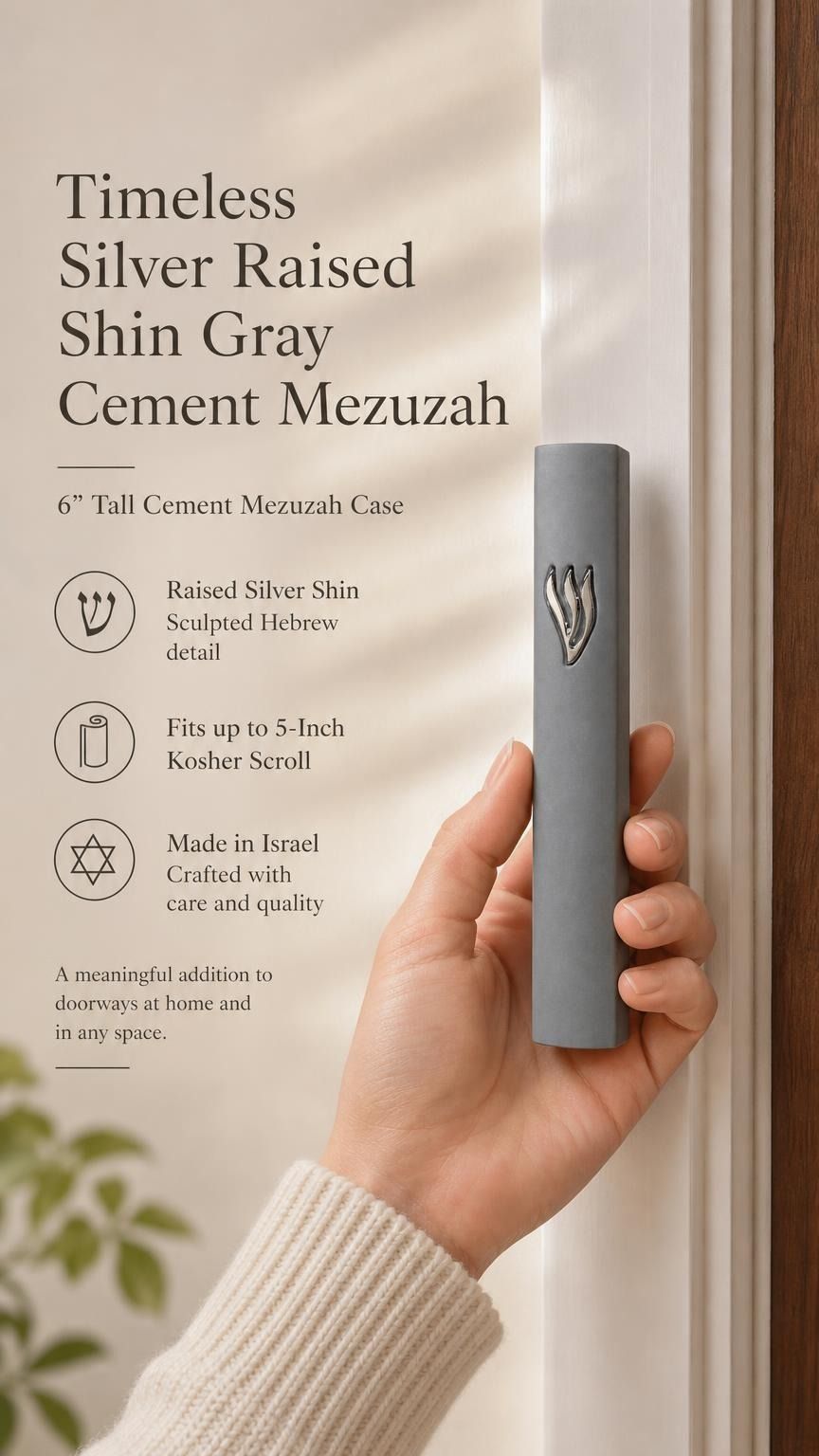 Handheld gray cement mezuzah case with a raised sculptural silver-tone Shin, shown beside product details to illustrate the slim proportions, smooth cement finish, minimalist design, and modern Jewish doorway style