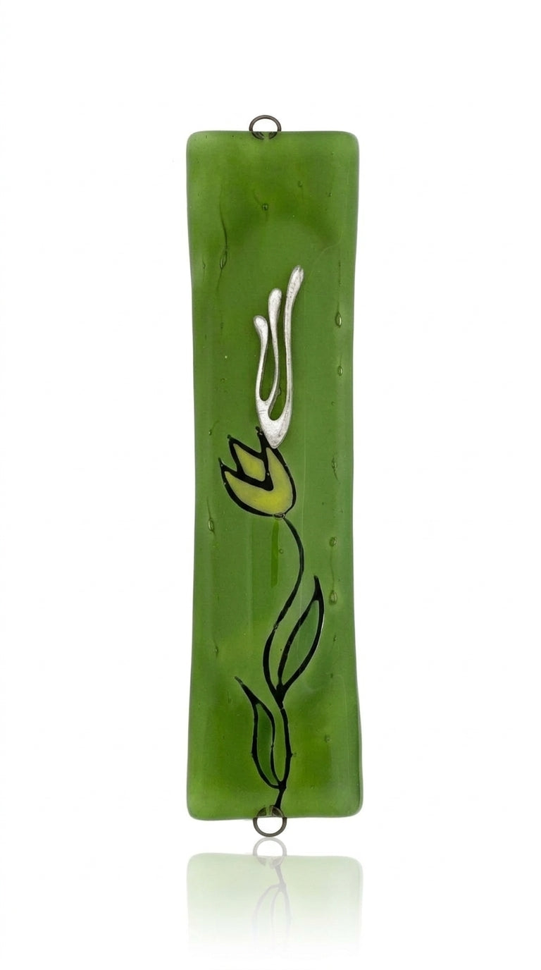 Made of glass with intricate floral and Hebrew motifs, green flower mezuzah displayed on a white background with soft reflection.