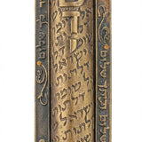 Large brass Mezuzah with Hebrew inscription 'Guardian of the doors of Israel', precise details, engraved text, and textured surface, on a white studio background with light reflection.