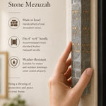 Person holding the handmade Jerusalem stone mezuzah, showing its size, material, and engraved blessing.