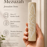 Person holding a Jerusalem stone Mezuzah in natural light, highlighting its texture and craftsmanship in a premium store setting.