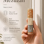 Person holding an authentic Jerusalem stone mezuzah, showcasing its textured layers, natural stone color variation, and meaningful design, in a premium store setting.