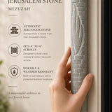 Person holding an extra large Jerusalem stone mezuzah, showcasing its brick-style relief and carved Shin, in a natural setting.