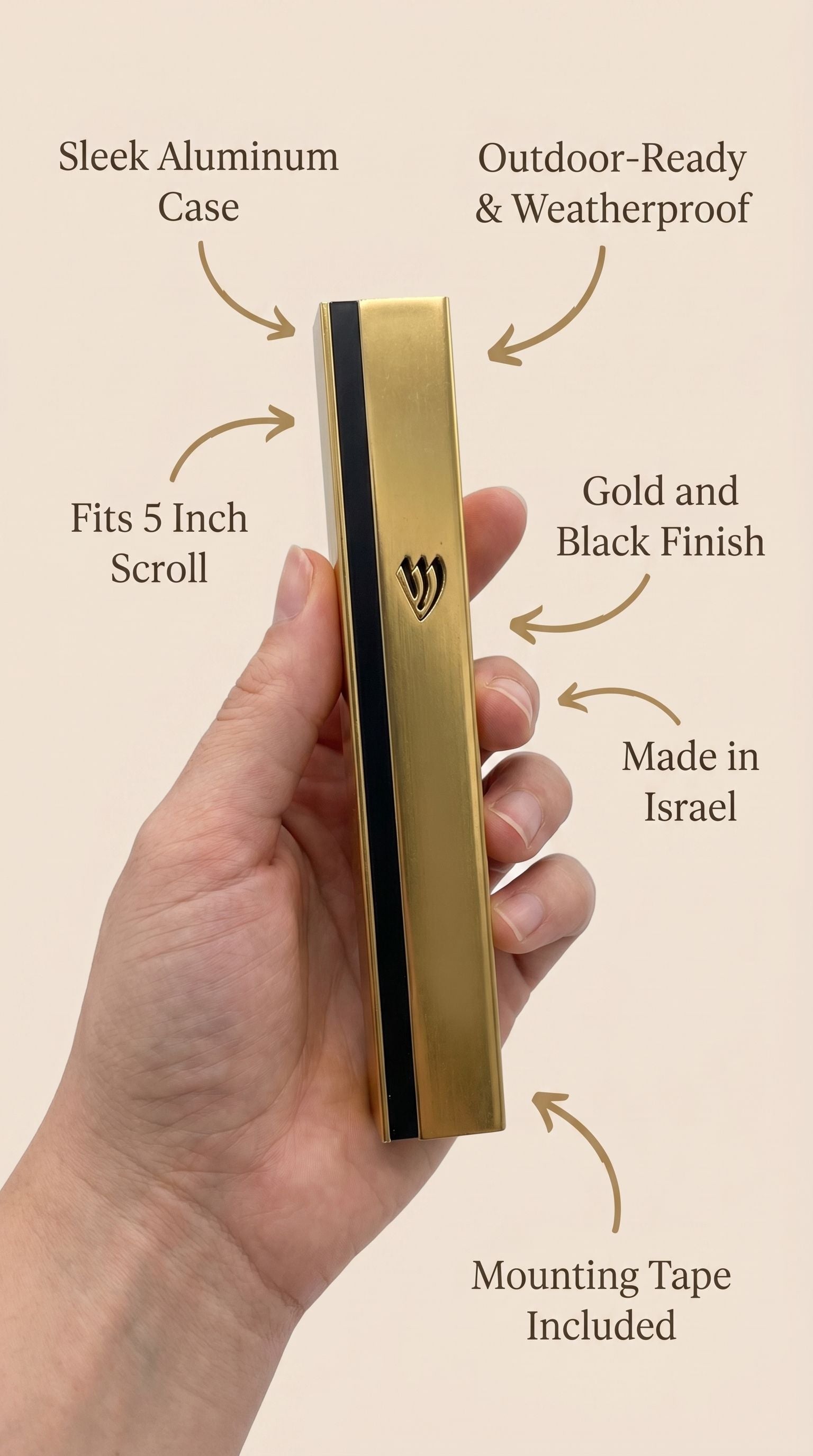 Person holding a gold and black aluminum outdoor mezuzah showing its material and design features.