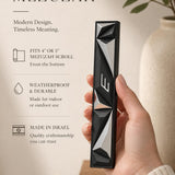 Close-up of person holding the authentic mezuzah with editorial styling, showcasing details and material in a vertical 9:16 format.