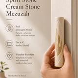 Person holding Jerusalem stone mezuzah showing texture, material, and size for product display.
