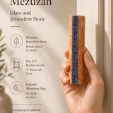 Close-up of a person's hand holding the Jerusalem stone and glass mezuzah, emphasizing its size, material, and craftsmanship for store promotion.