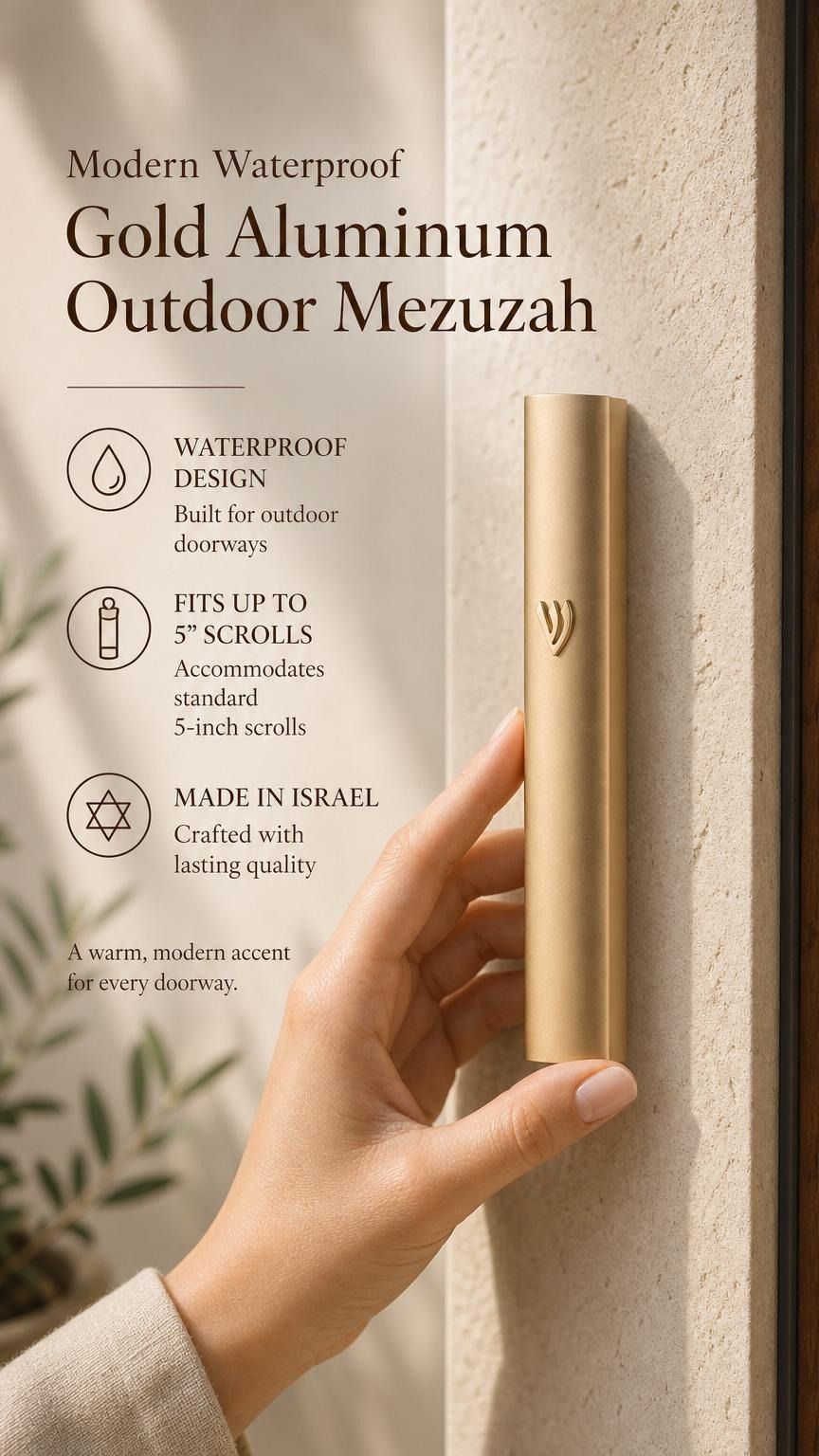Close-up of a person holding the gold aluminum outdoor mezuzah, with editorial text space on the side, highlighting its elegant simplicity and protective finish.
