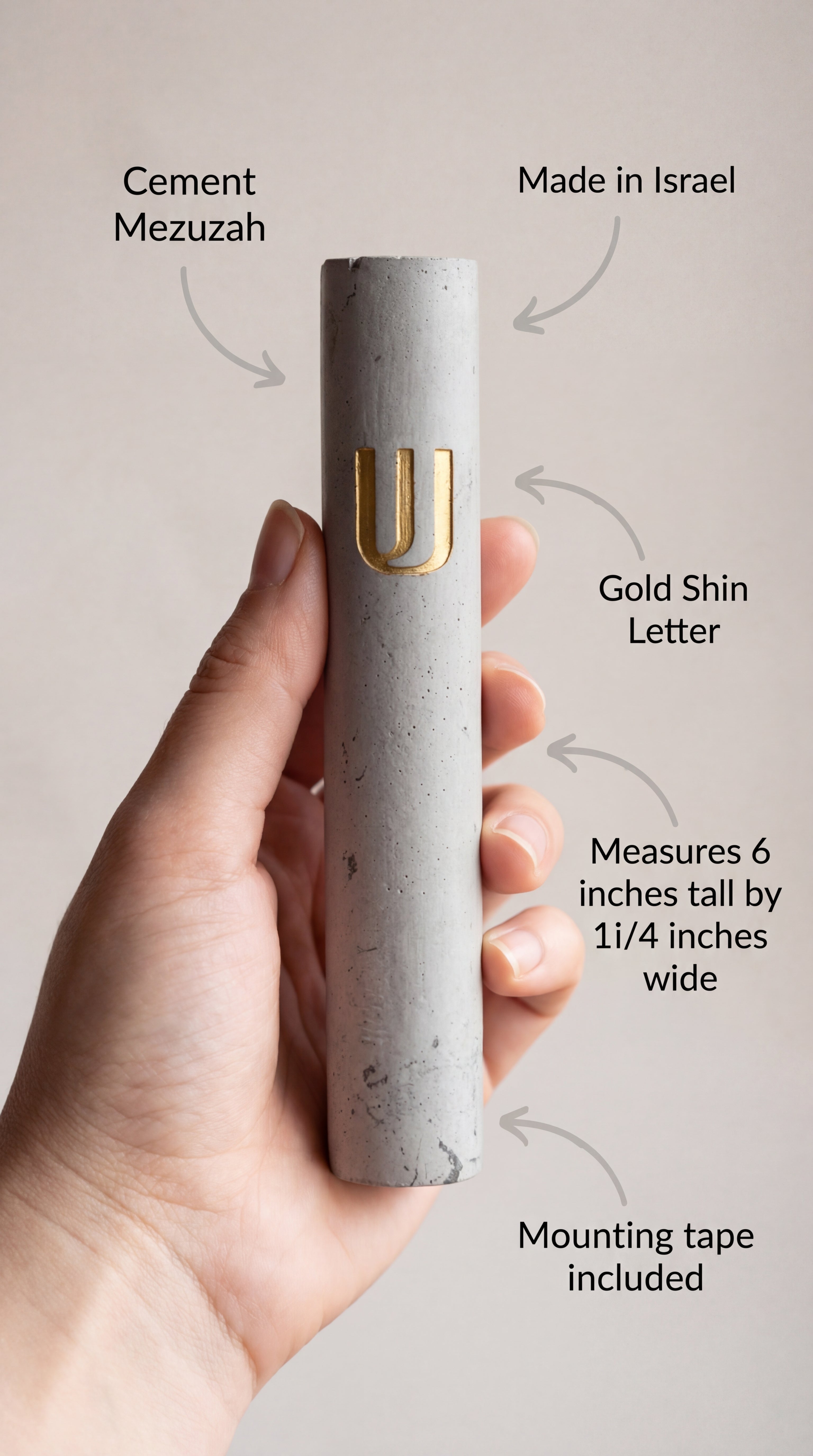 Person holding a gray cement Mezuzah with gold highlights, with curvy arrow annotations pointing to the mezuzah case features