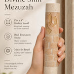 Hand holding the 5-inch Divine Shin cream Jerusalem stone mezuzah, showing the gold shin detail.