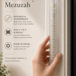 Hand holding the 5.5-inch clear acrylic mezuzah with silver Shema lettering.