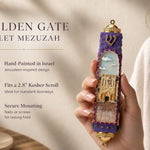 Person holding the Golden Gate Violet Mezuzah, showcasing its Jerusalem-inspired design and violet and gold tones, in a natural setting.