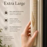Person holding Jerusalem stone mezuzah showing texture and size, with neutral background for focus.