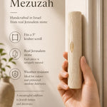 Person holding the authentic Jerusalem stone Golden Arch Mezuzah showing its texture and craftsmanship for a premium store display.